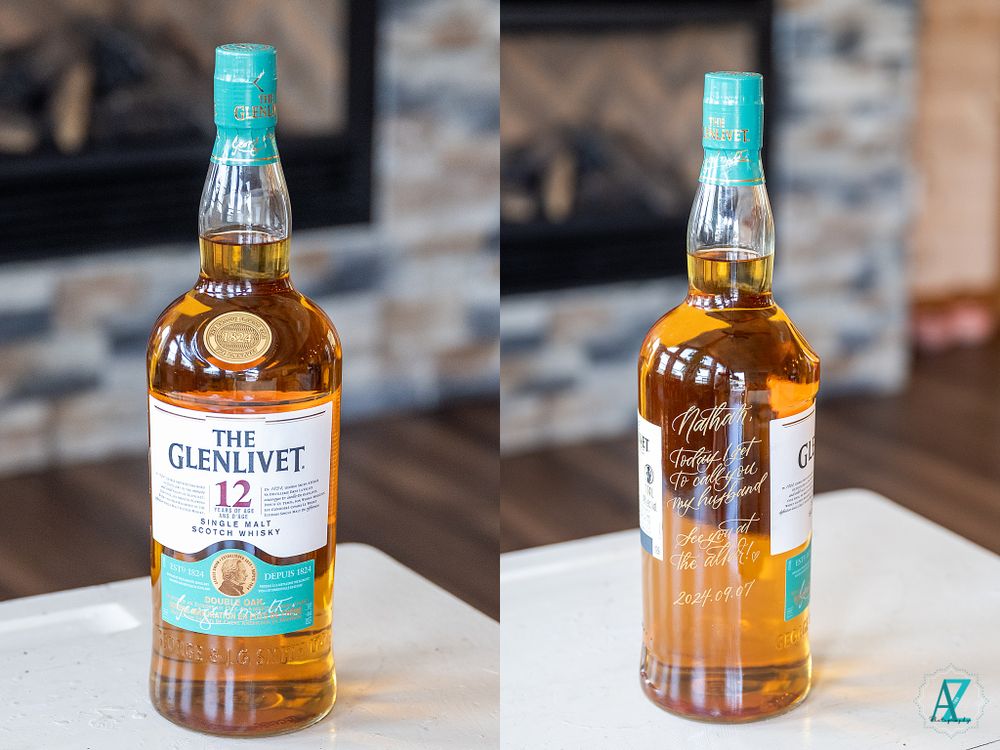 Two bottles of Glenlivet scotch whisky displayed on a wooden surface.
