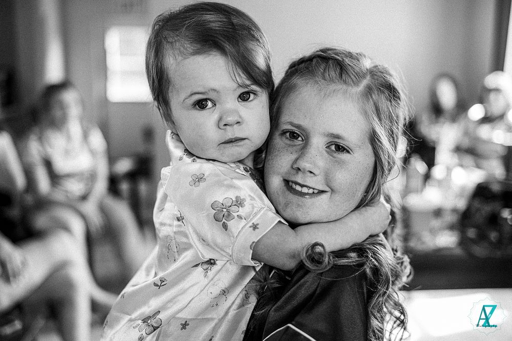Black and white portrait captured during intimate wedding preparation moments.