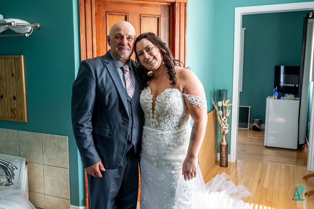 Emotional wedding day moment captured in a room with turquoise walls.