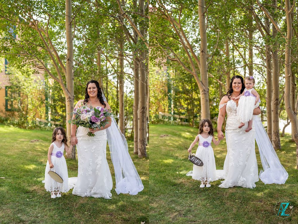 Outdoor wedding portraits among trees with flower girls in white dresses.
