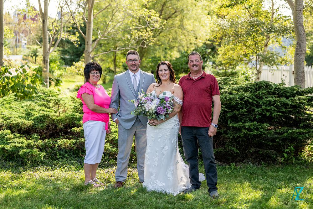 Garden wedding photo with bright casual and formal attire combinations.
