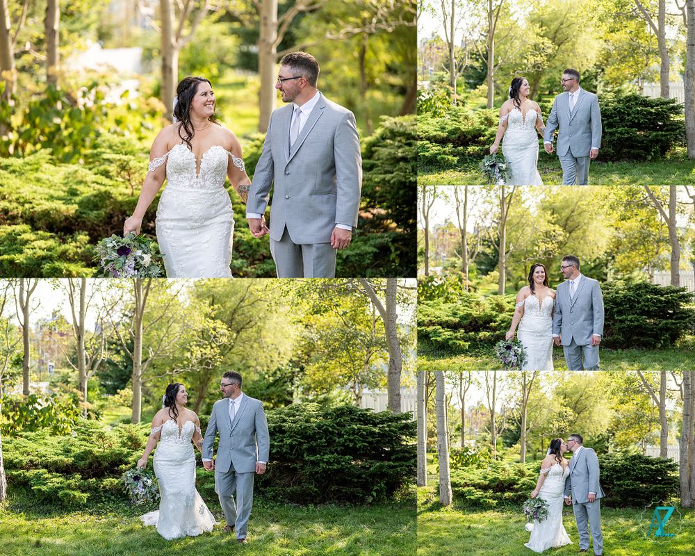 Wedding couple poses for romantic portraits in a lush garden setting wearing gray and white attire.