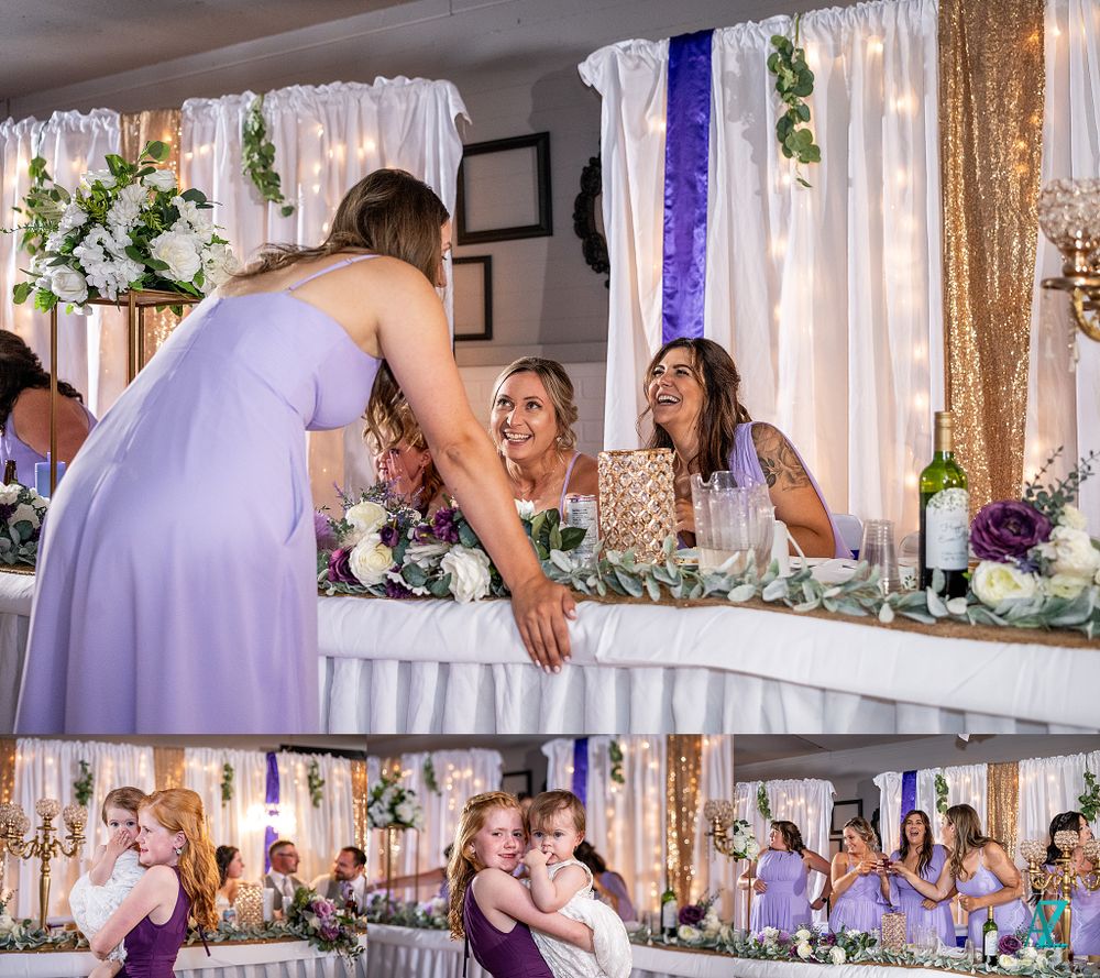 Wedding guests share joyful moments at the head table during reception celebrations.