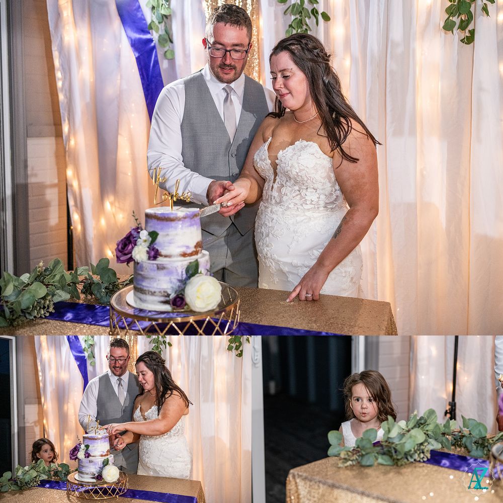 Newlyweds cut their elegant purple and white wedding cake together at the reception.