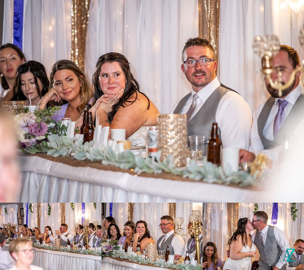 Wedding party members smile and celebrate at the elegantly decorated reception head table.