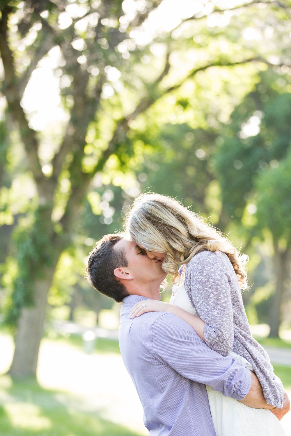 Sweet candid moments between couple during outdoor photo session in a park.