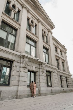 Classic neoclassical stone building facade with decorative columns and architectural details.