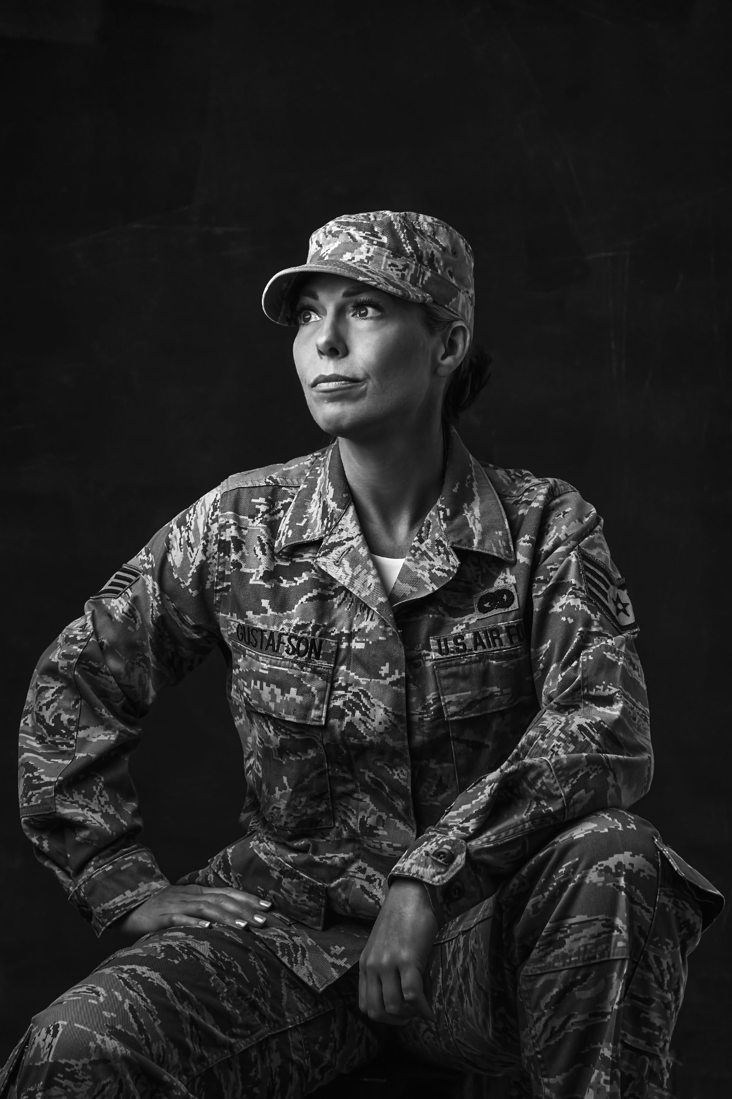 Dramatic black and white portraits showing person in camouflage military uniform.