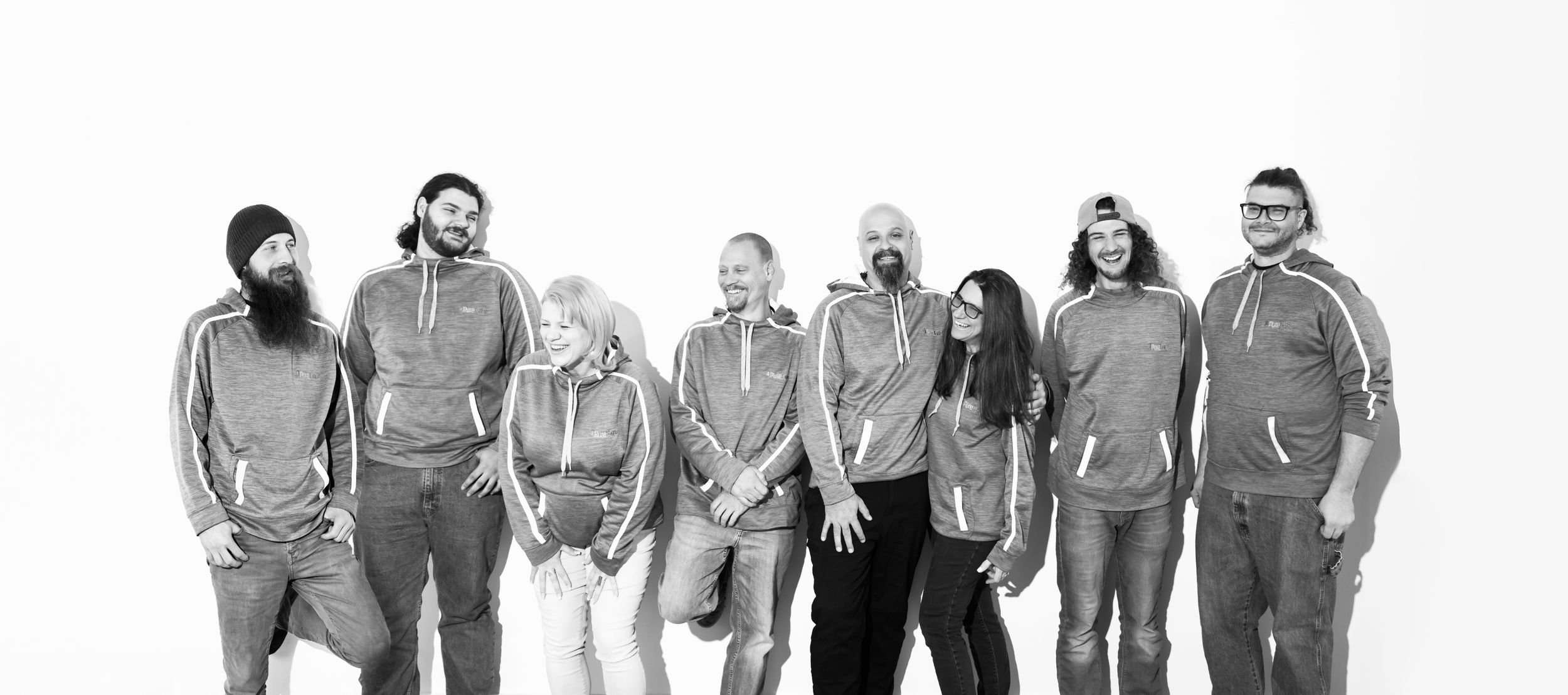Series of black and white group portraits showing different poses against white background.