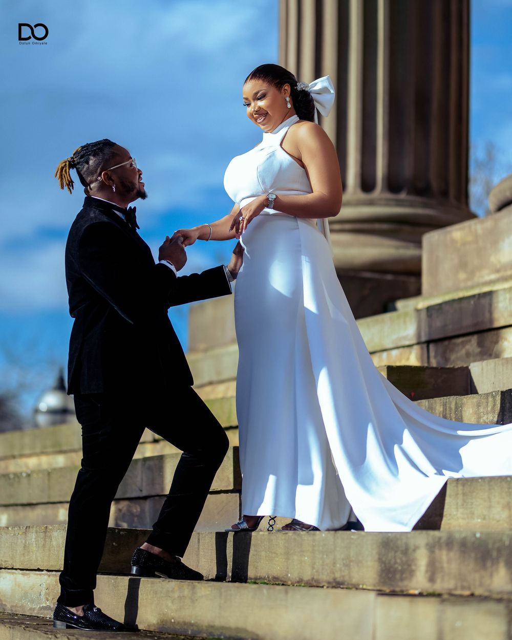 A romantic sequence showing a marriage proposal on stone steps against a bright blue sky background.