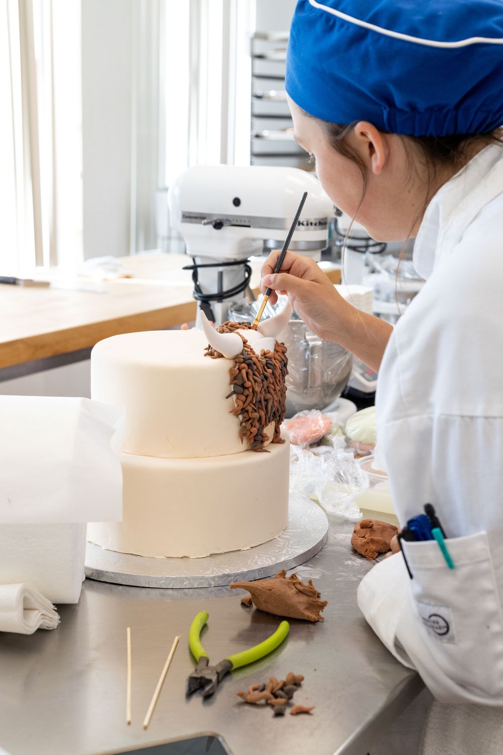 Pastry Chef student painting a cake