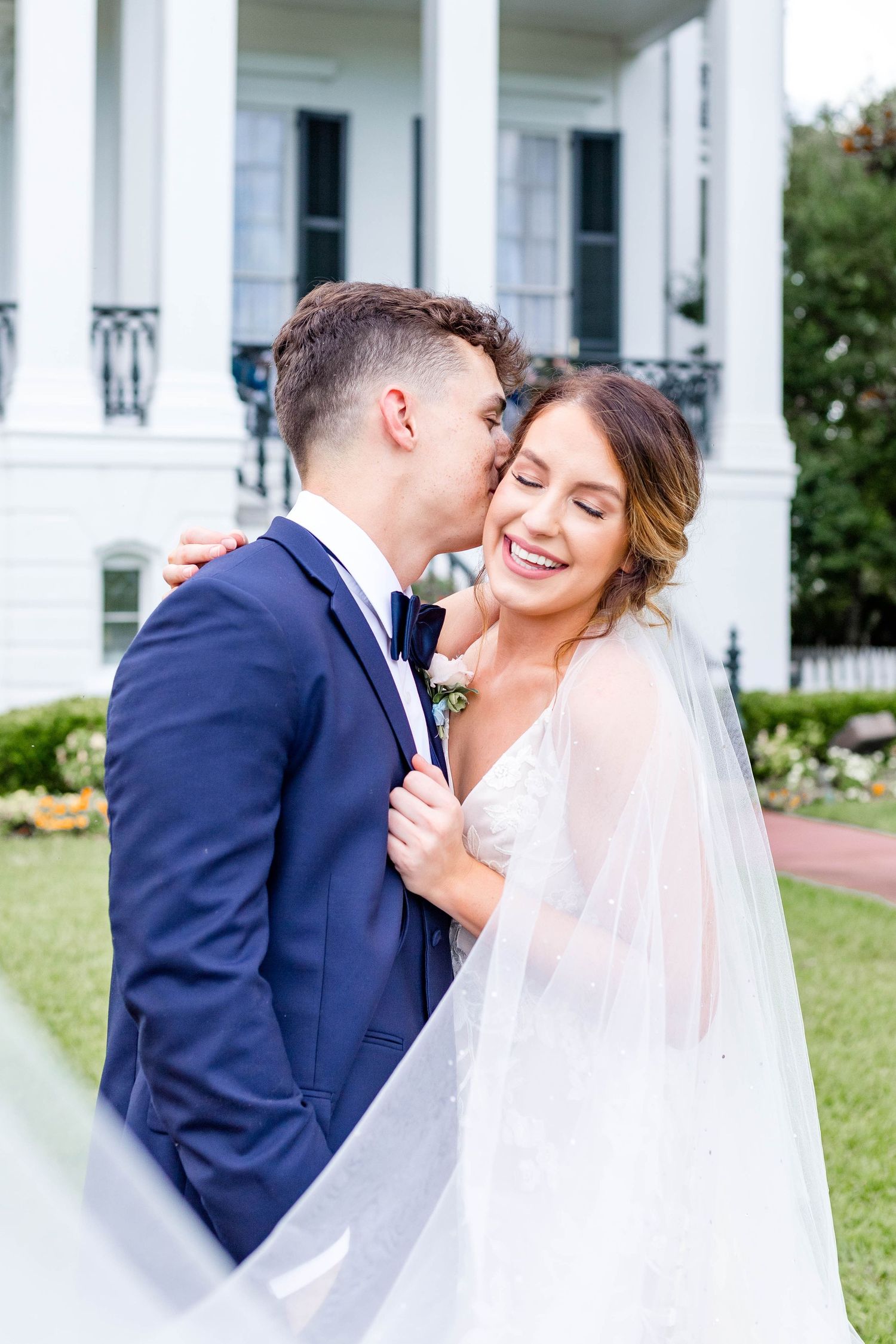 groom kisses bride on the temple at nottoway from baton rouge wedding photographers