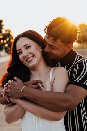 kansas city engagement photography, couple embracing with sunburst