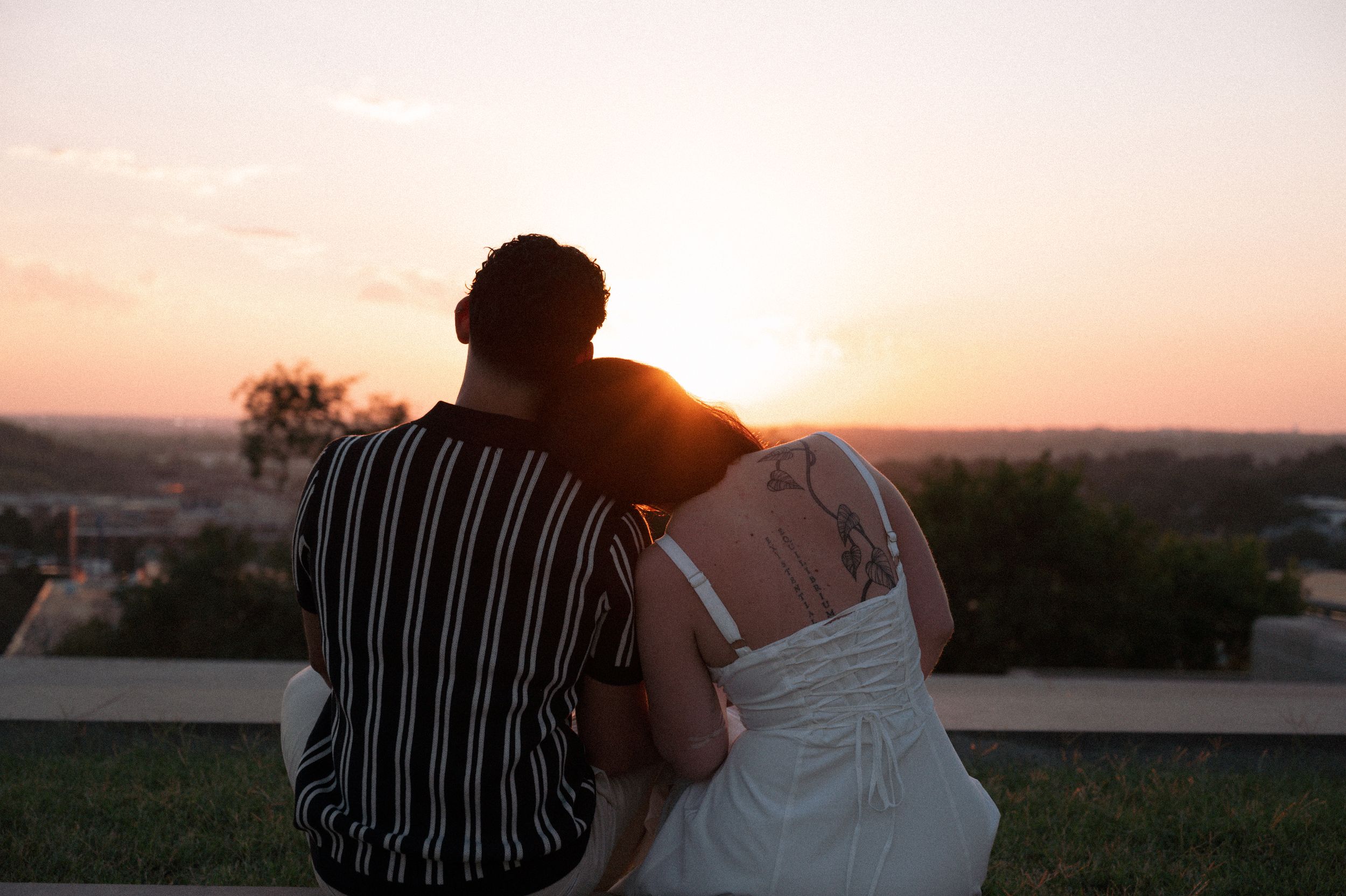 kc engagement session, man and woman looking into sunset