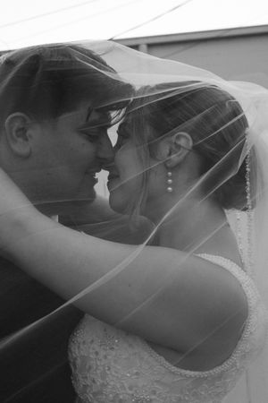 Bride and groom kiss under veil, close up captured  by KC wedding photograper