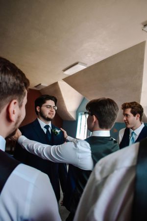 kansas city wedding photography, groomsman holds groom shoulders smiling
