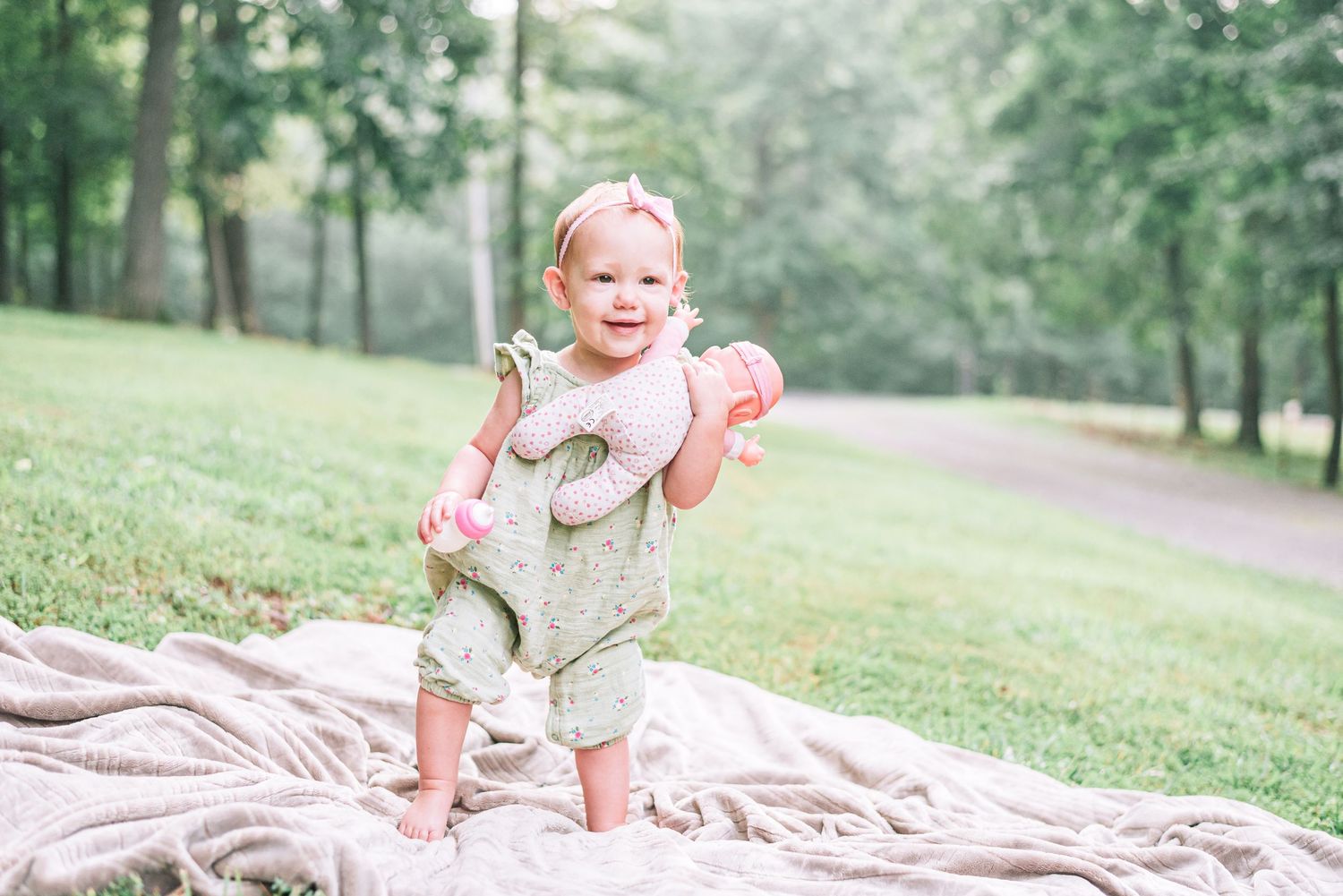 A baby girl smiling for her one year old portraits in western Kentucky.