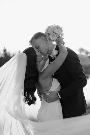 Intimate black and white portrait of newlyweds sharing romantic moment.