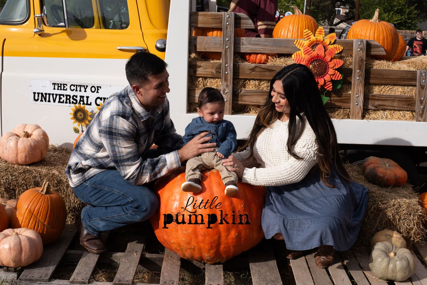 A fall themed photo setup with pumpkins and hay bales at the Universal City Pumpkin Patch.