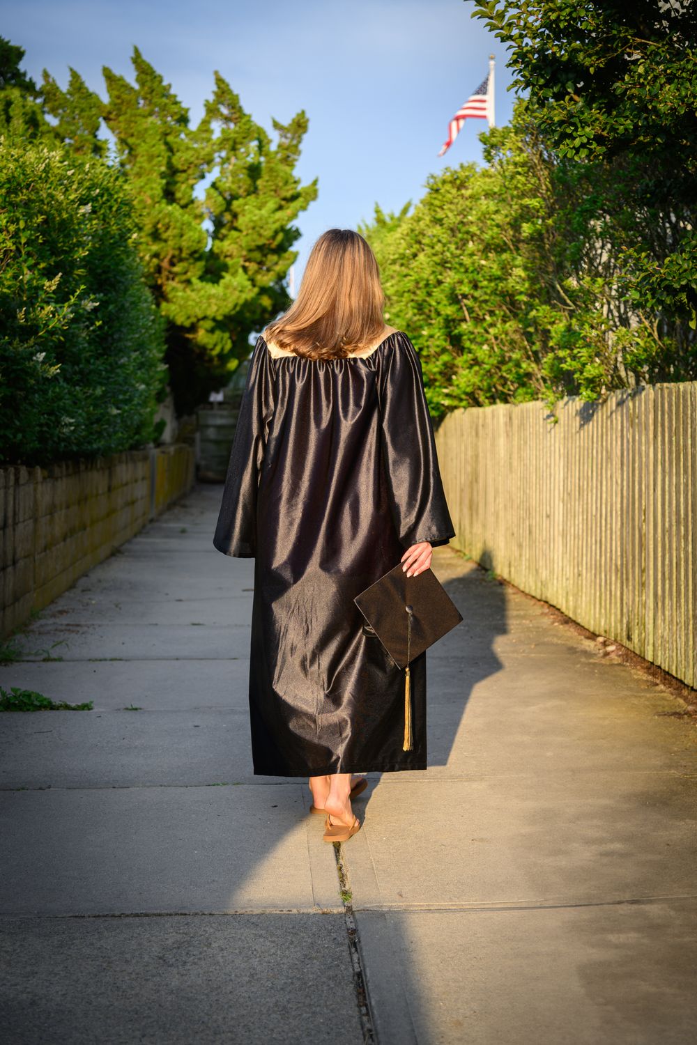 A sequence of photos showing someone walking away on a concrete path bordered by a bamboo fence and green trees.