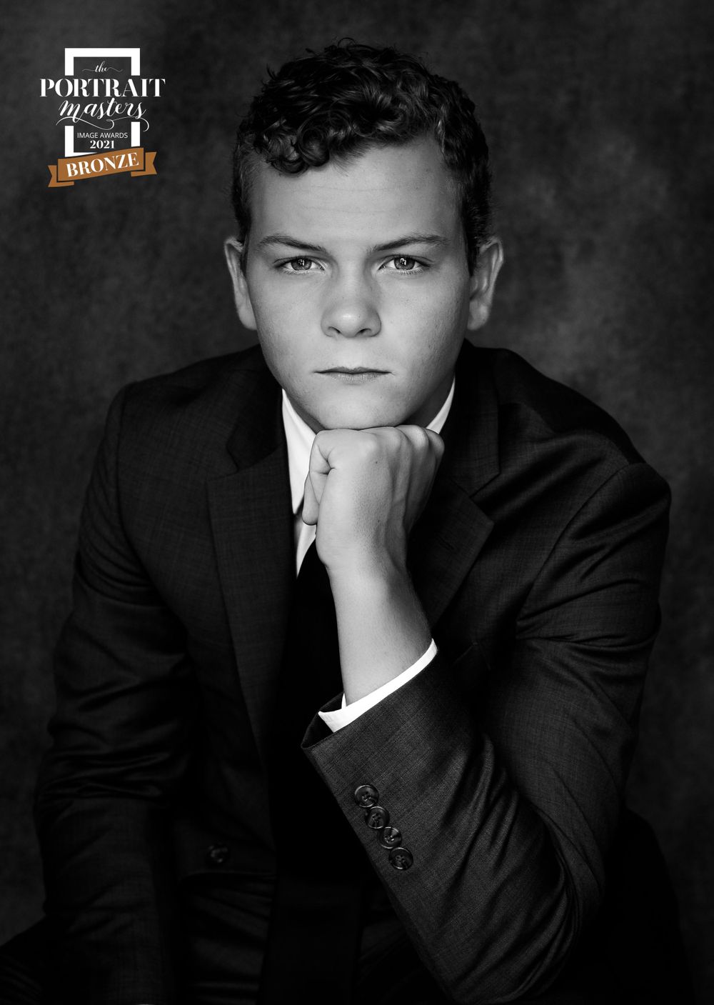 Classic black and white formal portrait series in dramatic lighting.