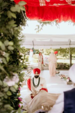 Outdoor wedding ceremony setup with traditional decor and floral arrangements.