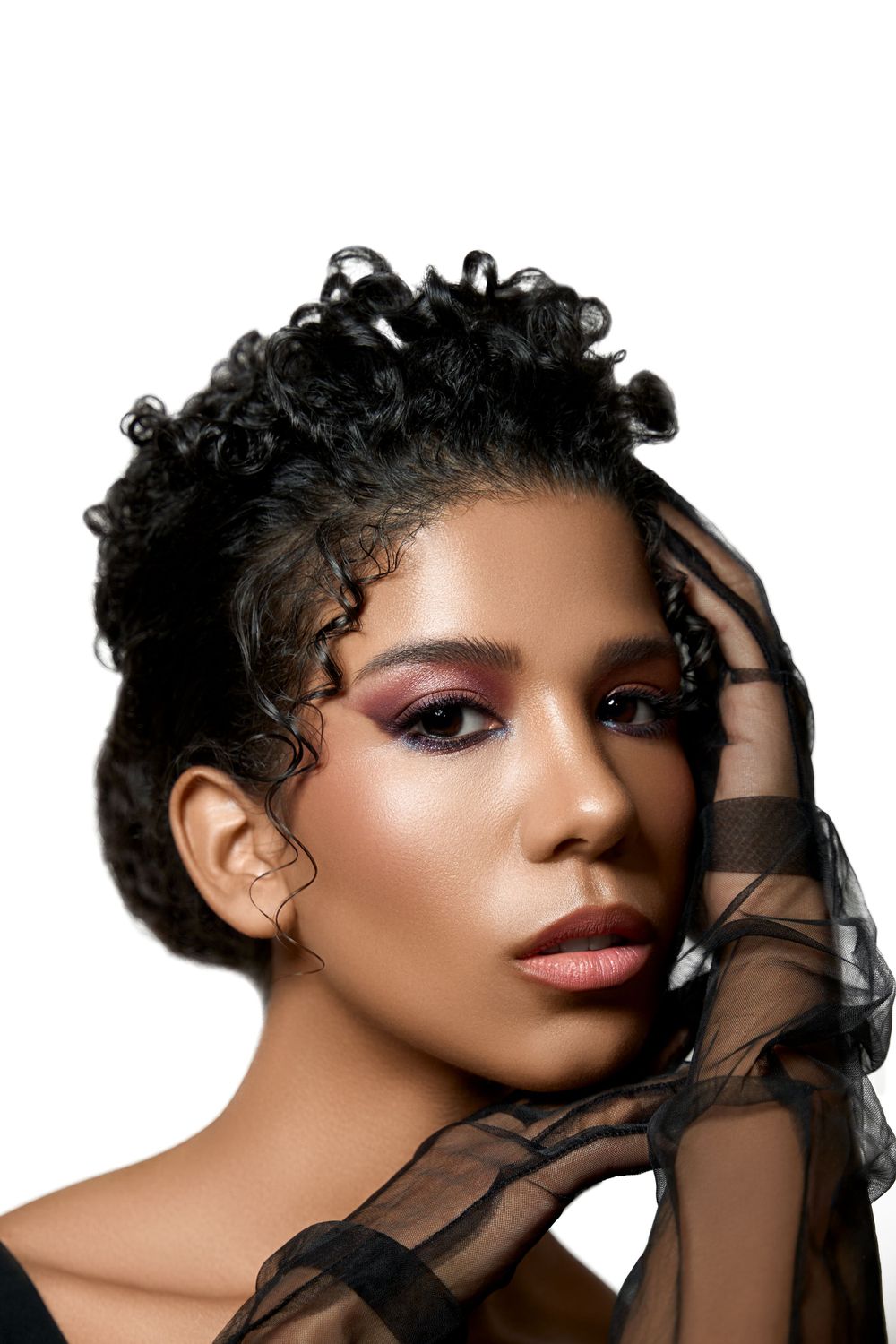 Close-up of model with plum eyeshadow and mesh gloves, editorial beauty style, photographed in NYC.
