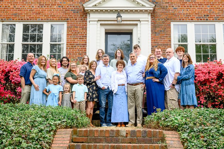 extended family of 22 at home in front of house