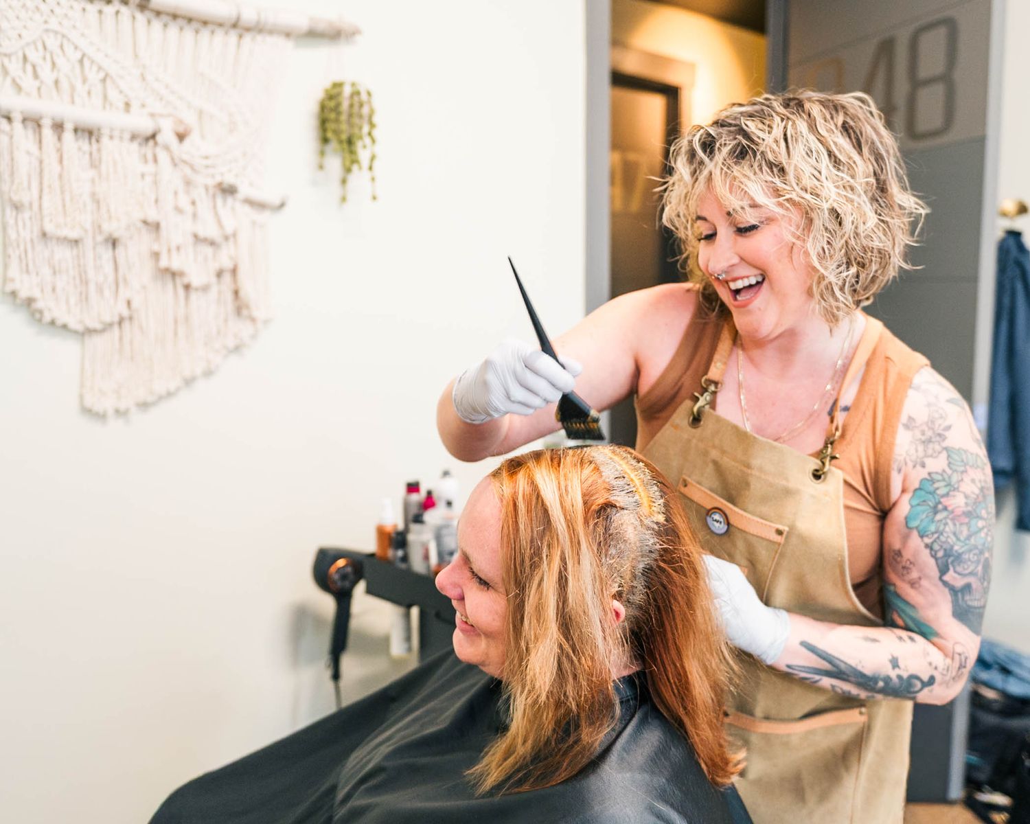 Bloomington, Illinois hairstylist providing a hair coloring service during a salon branding photography session by Julie Loy Photography