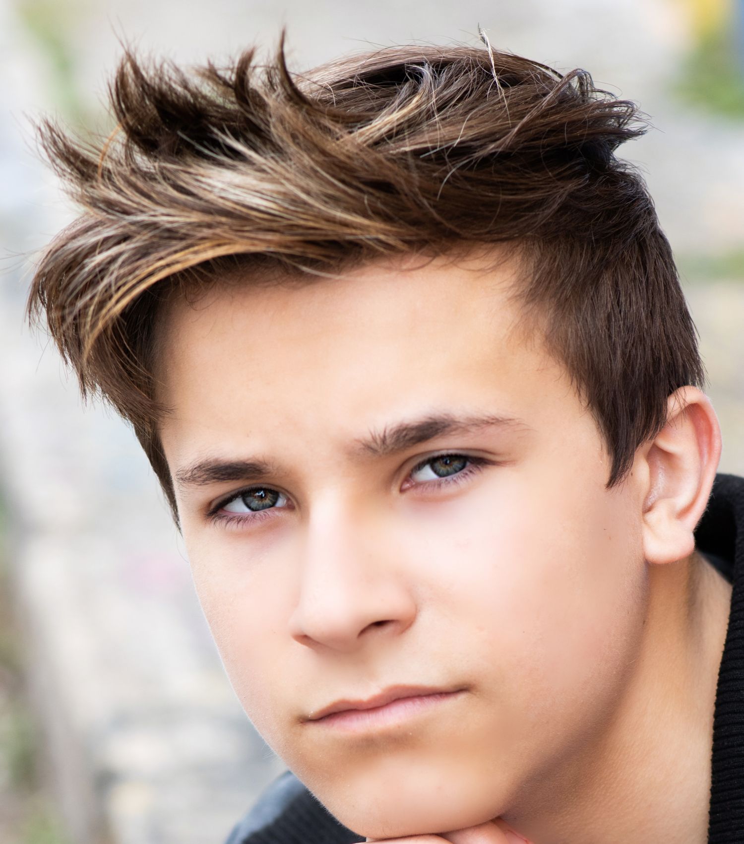 Close-up beauty shot featuring stylish spiked hair and natural lighting.