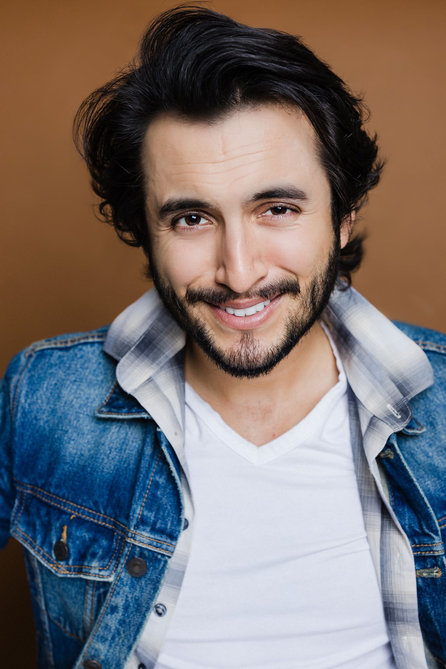 Portrait series showing a smiling person in denim jacket and white shirt against brown background.