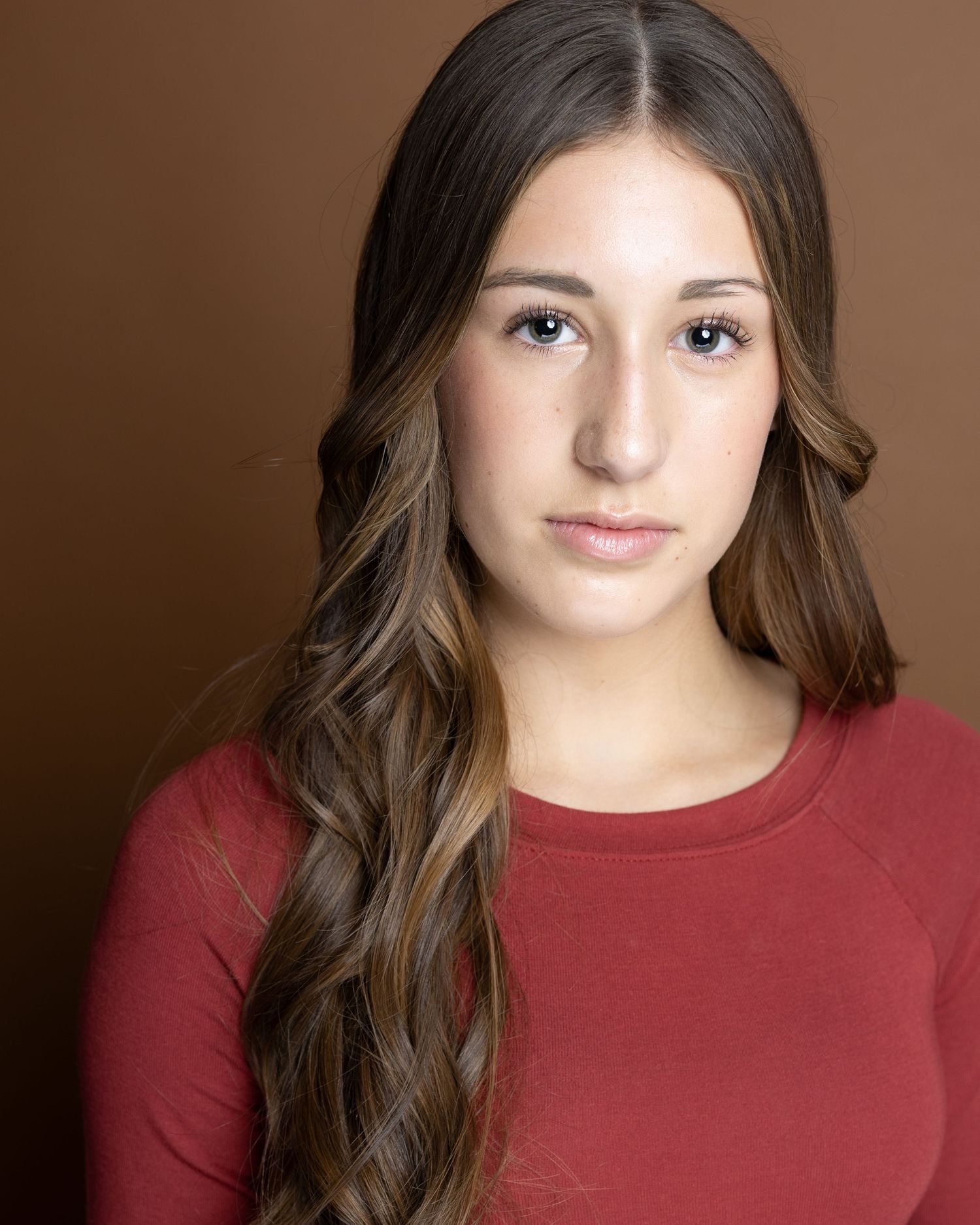 A captivating portrait series showing expressions and poses in a warm brown studio setting.
