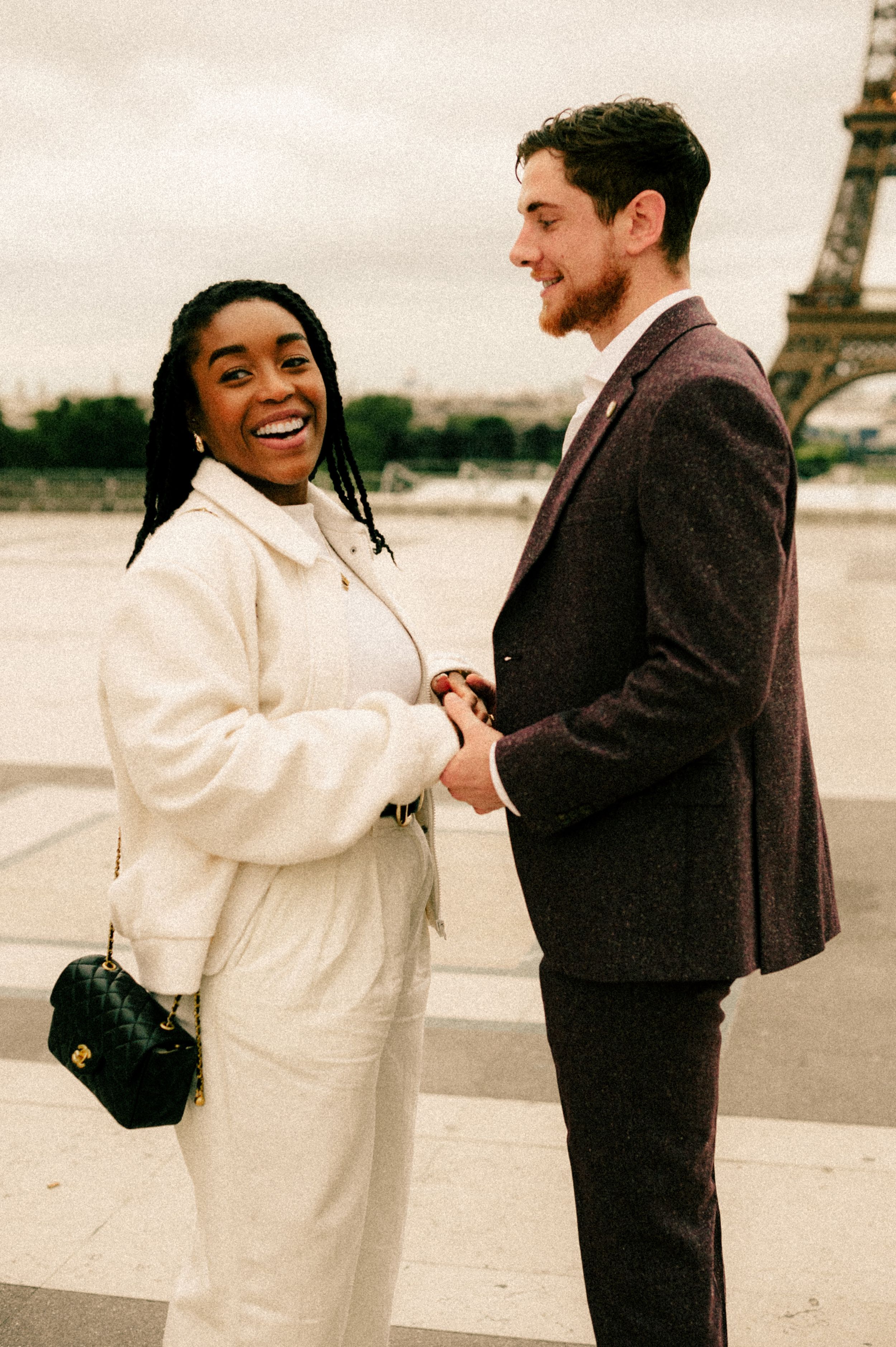 A joyful couple shares a romantic moment at the Trocadero overlooking the Eiffel Tower.