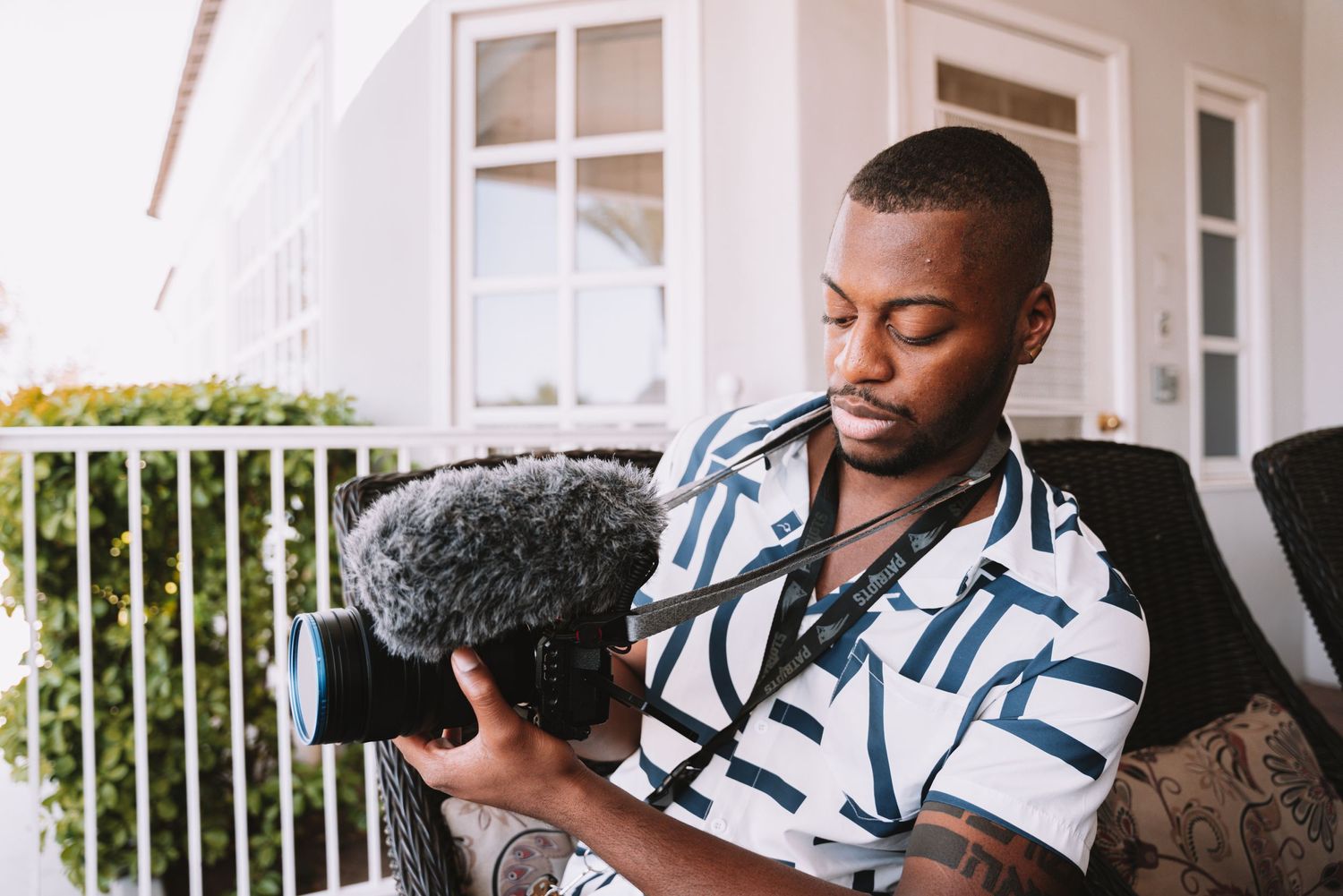 Content creator holding professional camera equipment outdoors.
