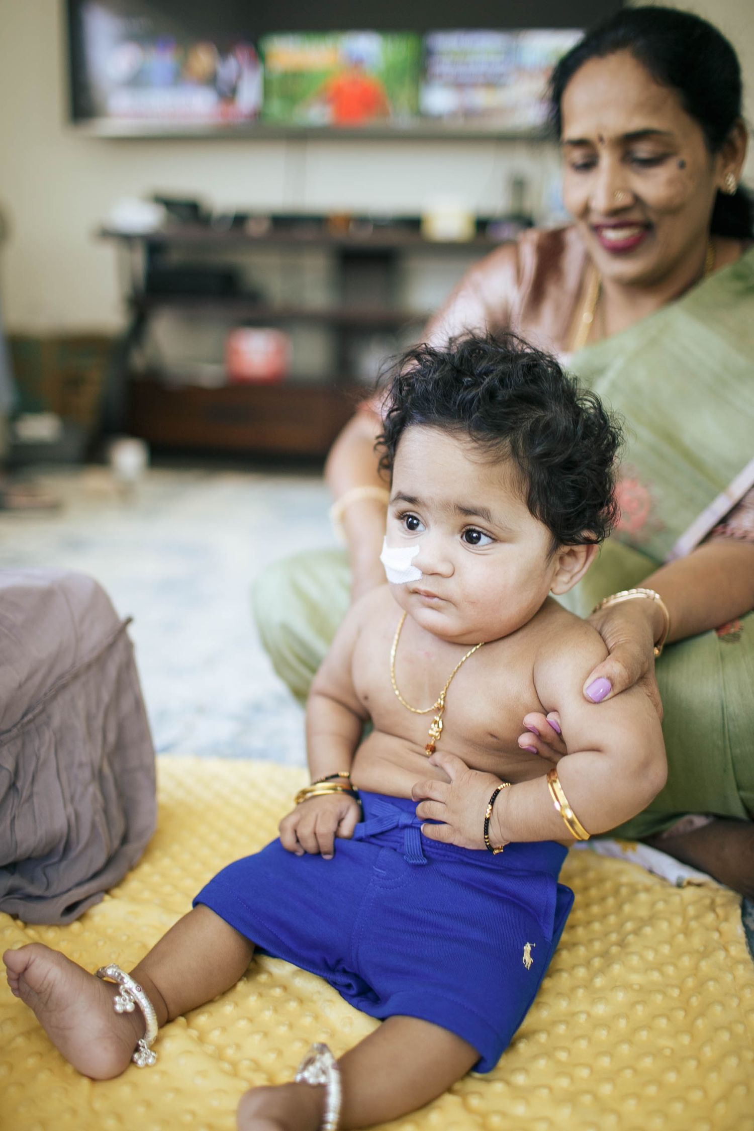 Seattle in-home family photography: a grandmother holds her 1-year-old grandson at an in-home family photo session