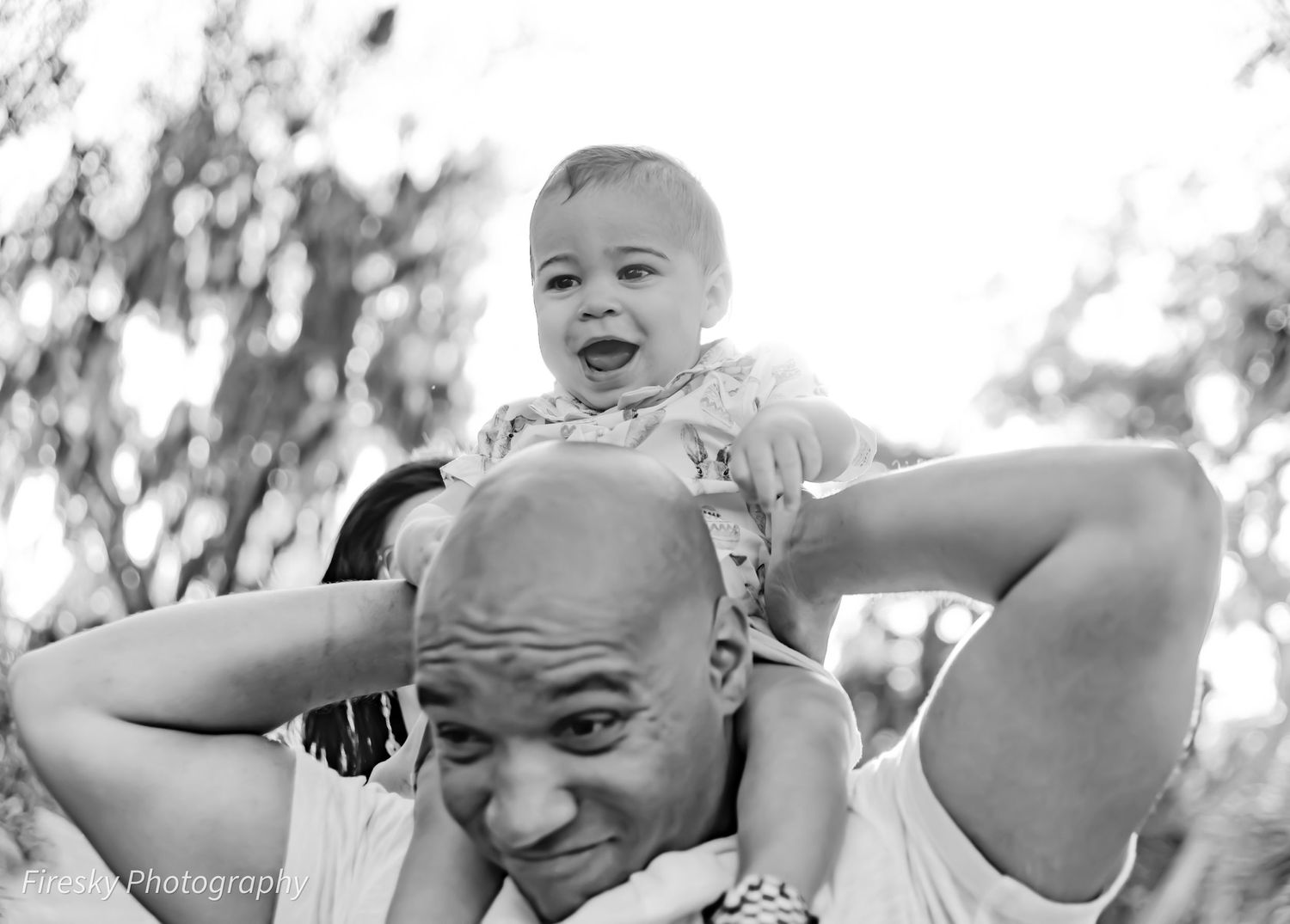 A heartwarming black and white image showing a playful moment between parent and child.