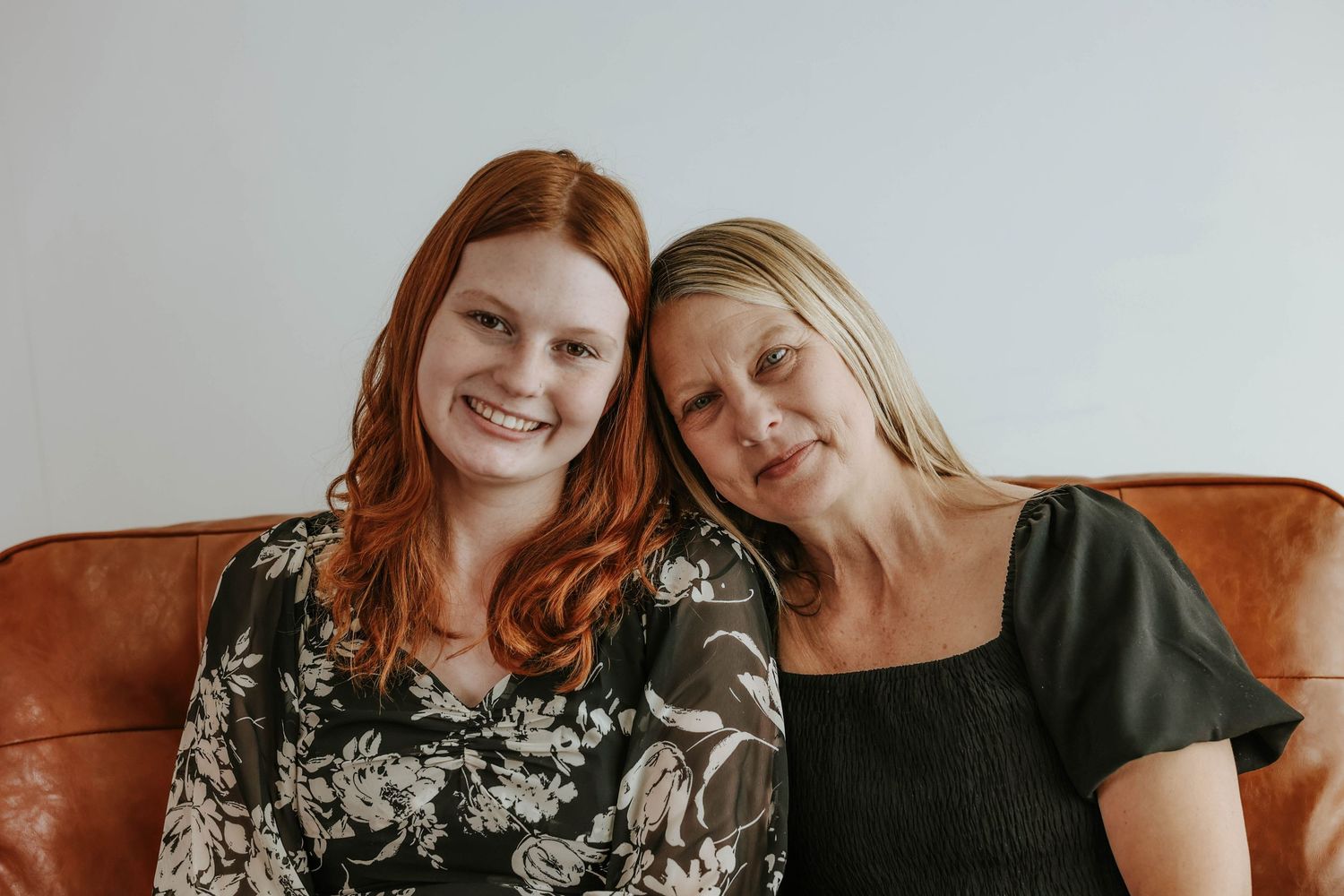 Jan and Anna celebrate together against a white background.