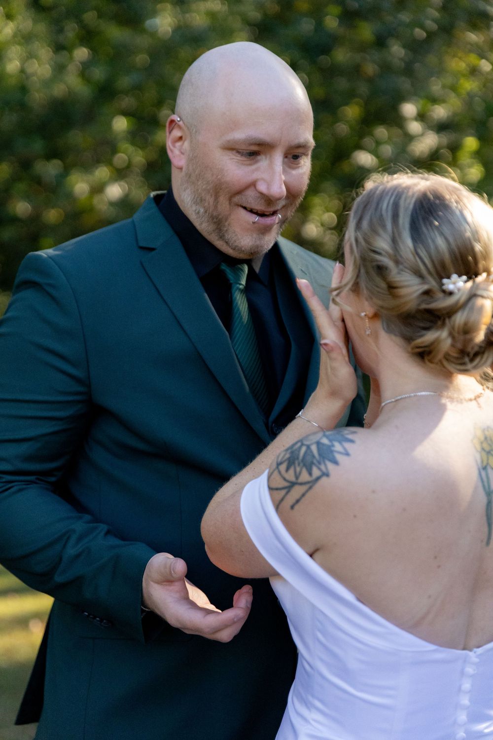 Intimate sequence of wedding couple sharing tender first look moment in outdoor garden setting.