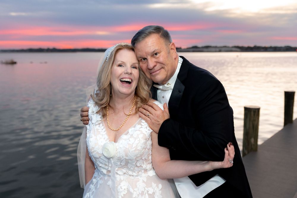 A couple in wedding attire embraces during sunset by the water with multiple photos showing different romantic poses.