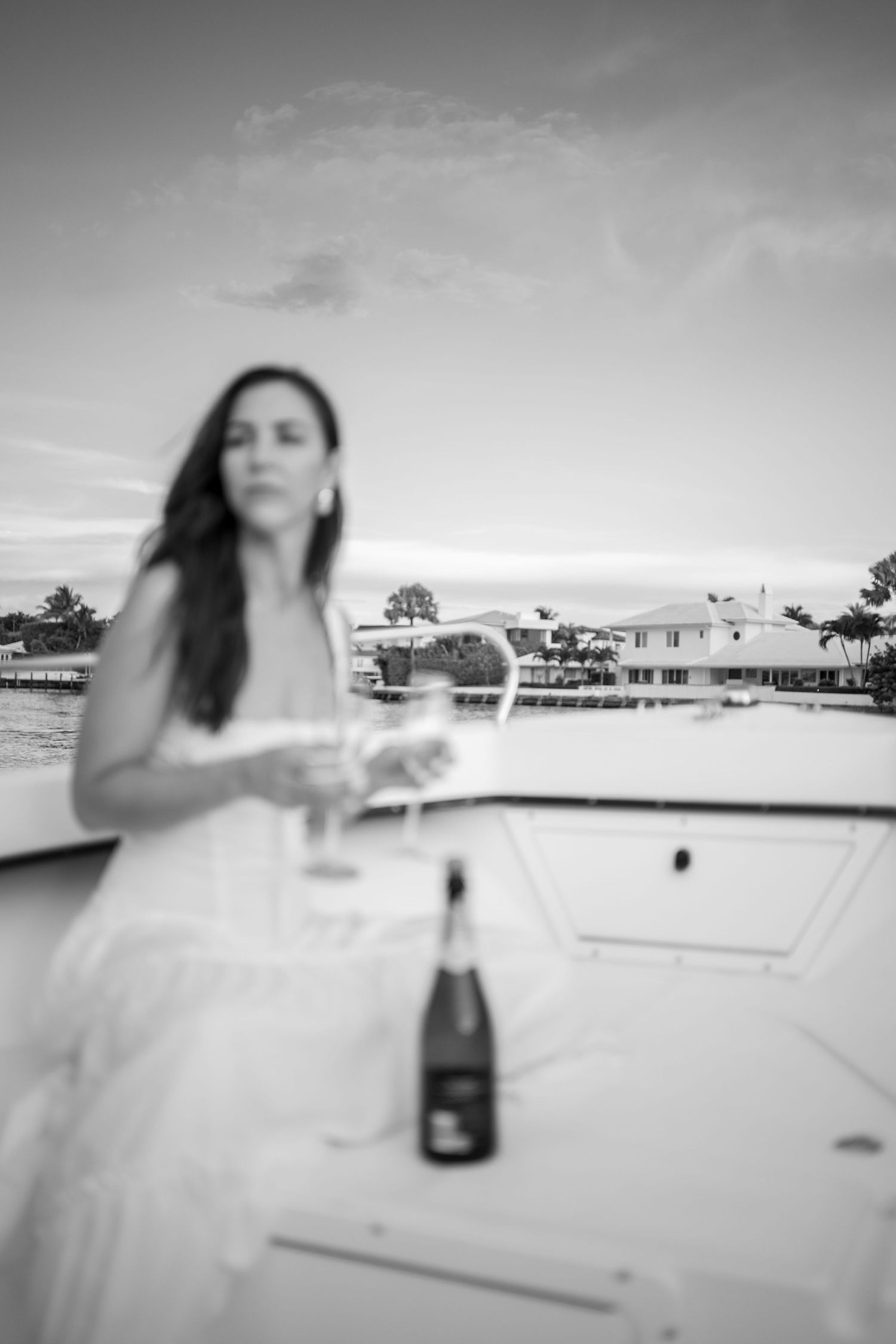 Black and white sequence of celebratory moments on a boat deck with champagne.
