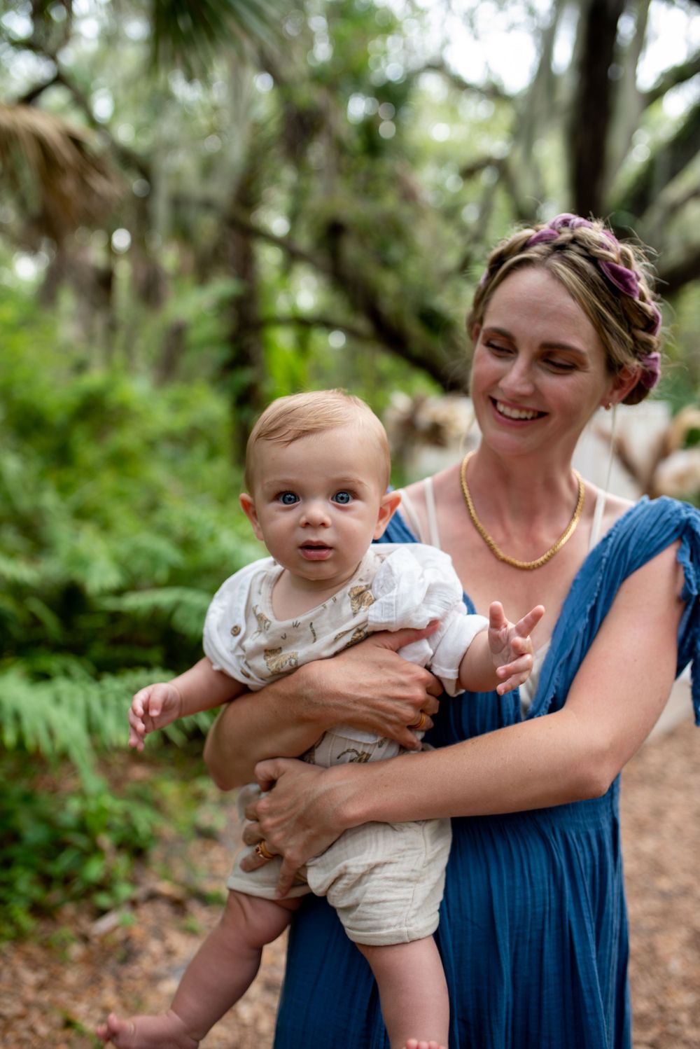 Playful moments captured between family members on a wooded path.