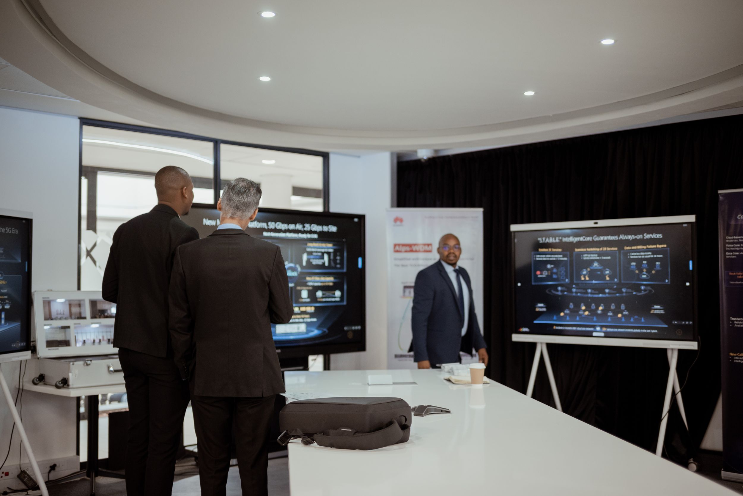 Corporate presentation setup with digital displays and technology in a modern office space.