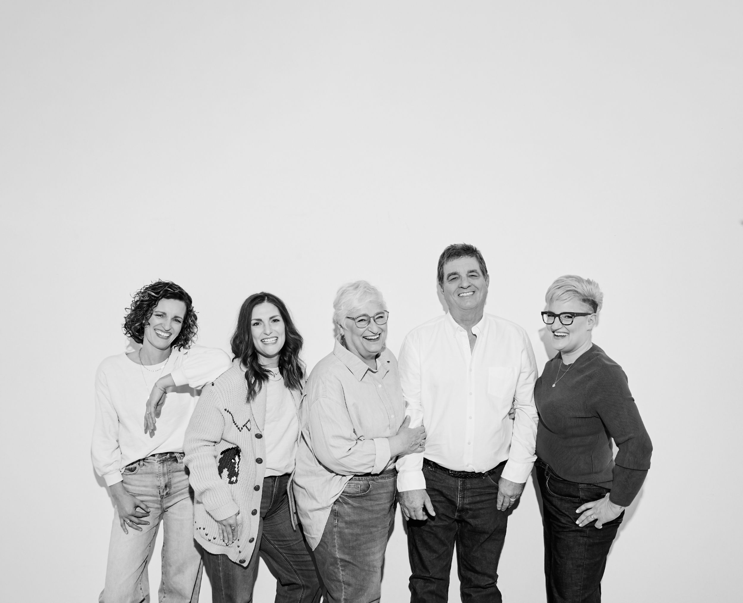 Black and white group portrait series showing people standing together in casual poses.