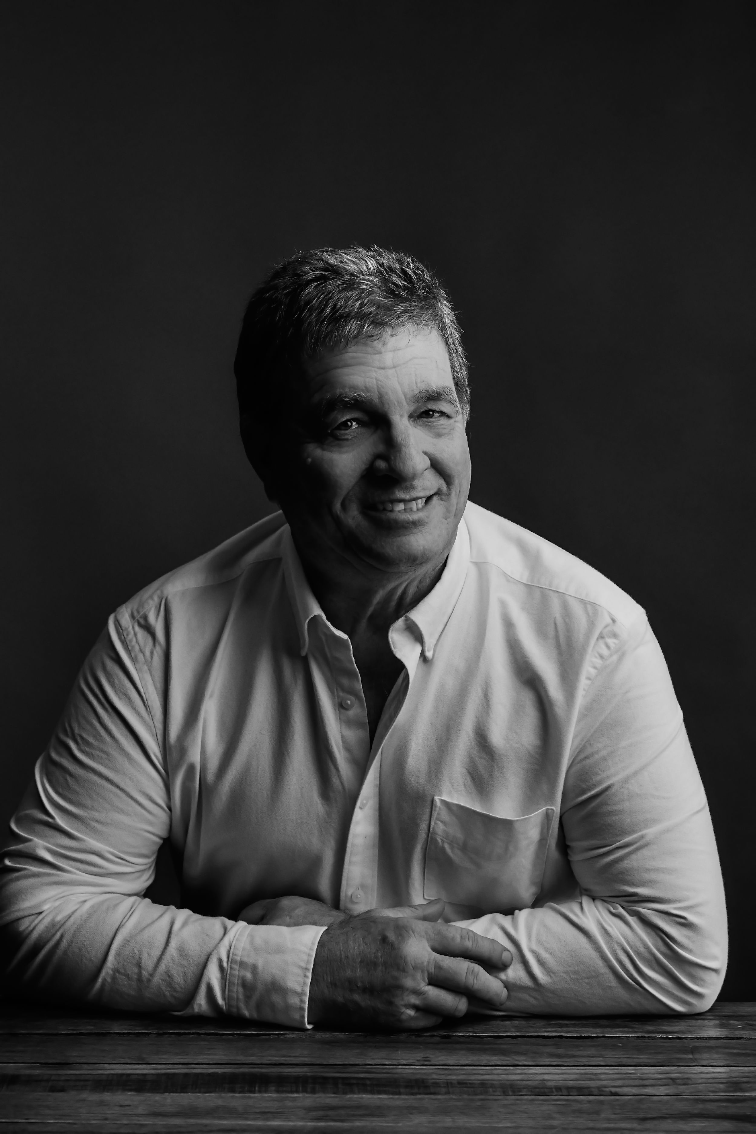 Dramatic black and white portrait series showing expressions and poses against dark background.