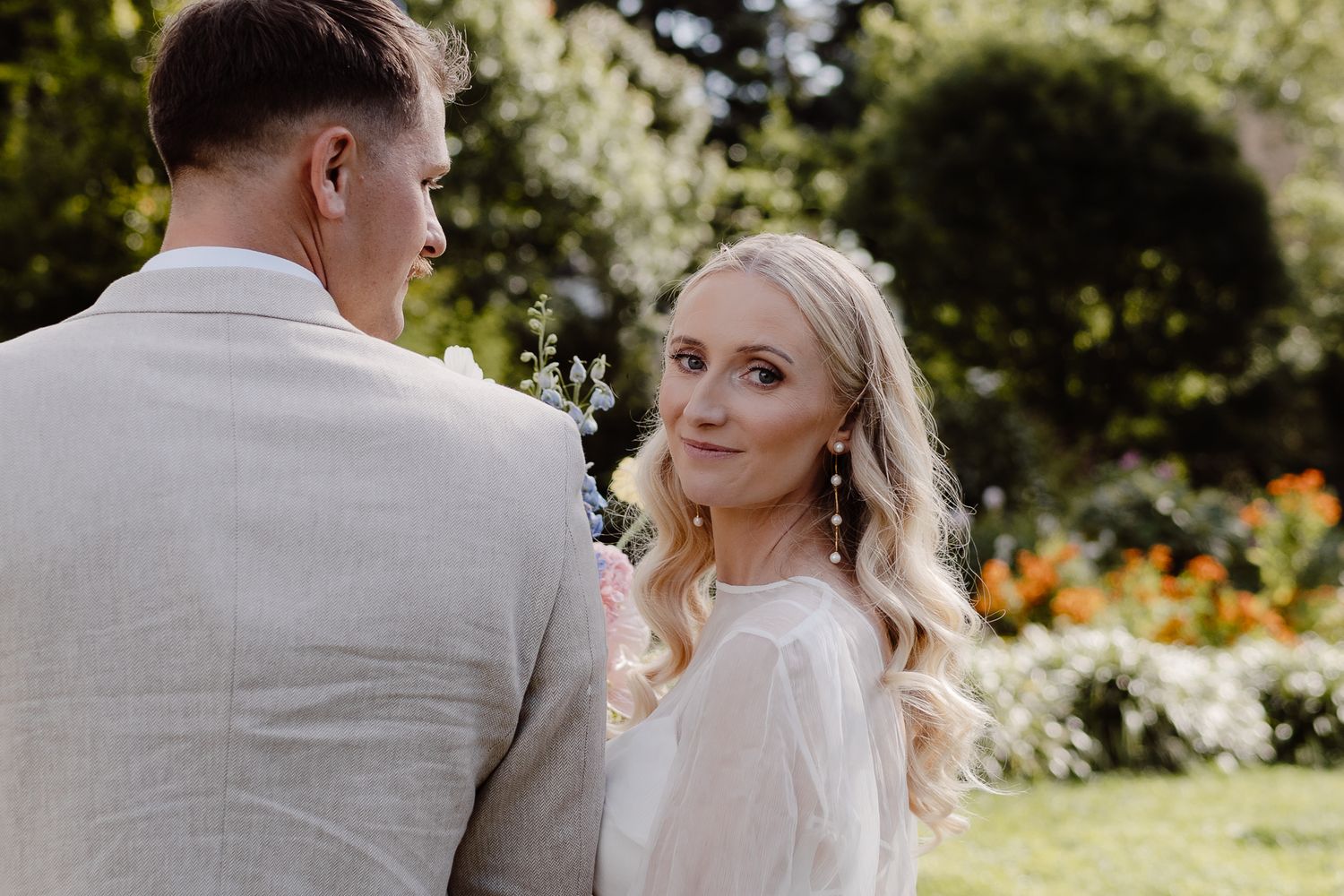 professional wedding portrait of a bride looking over her shoulder and smiling