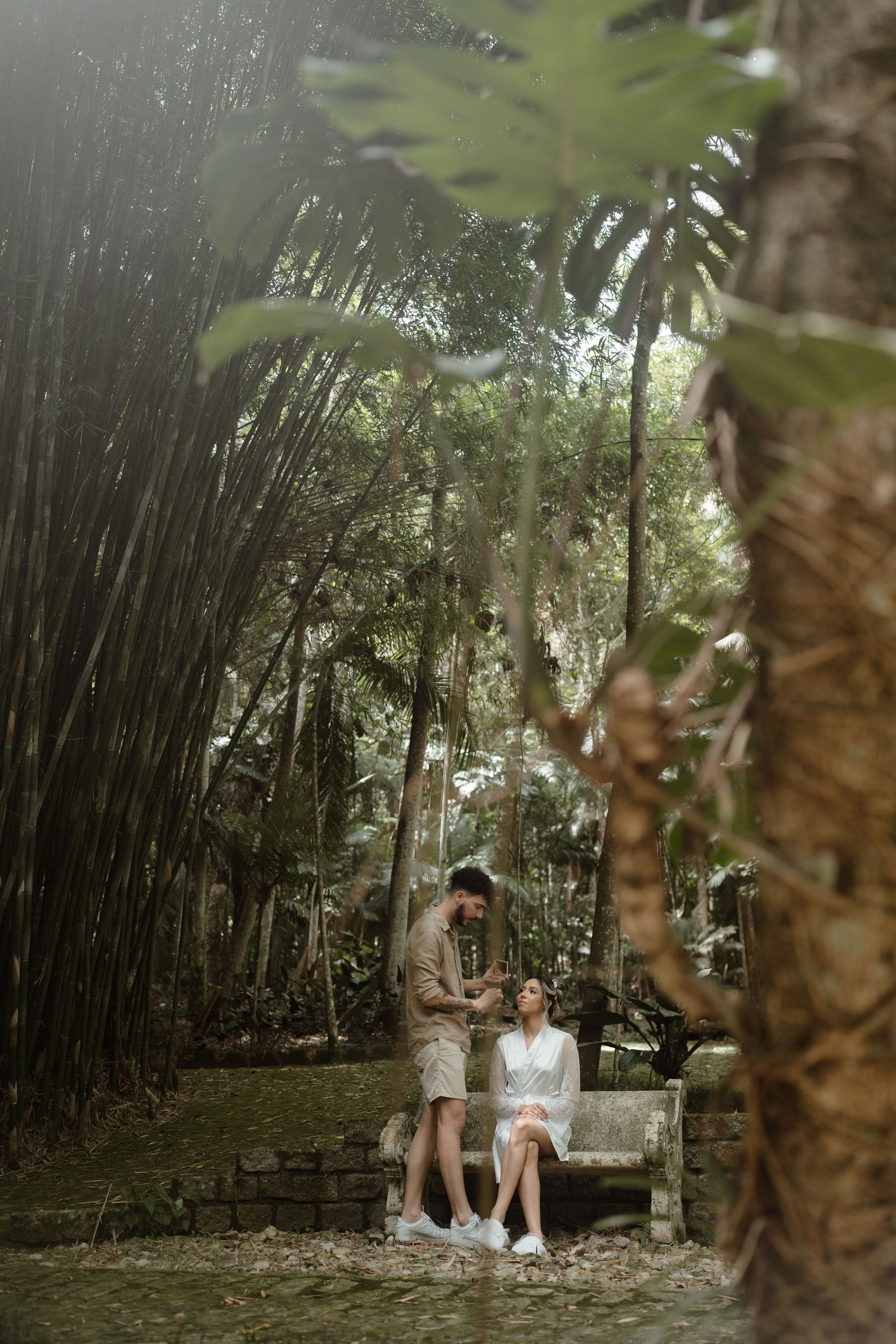 Tranquil bamboo forest setting with stone benches and tropical landscaping.