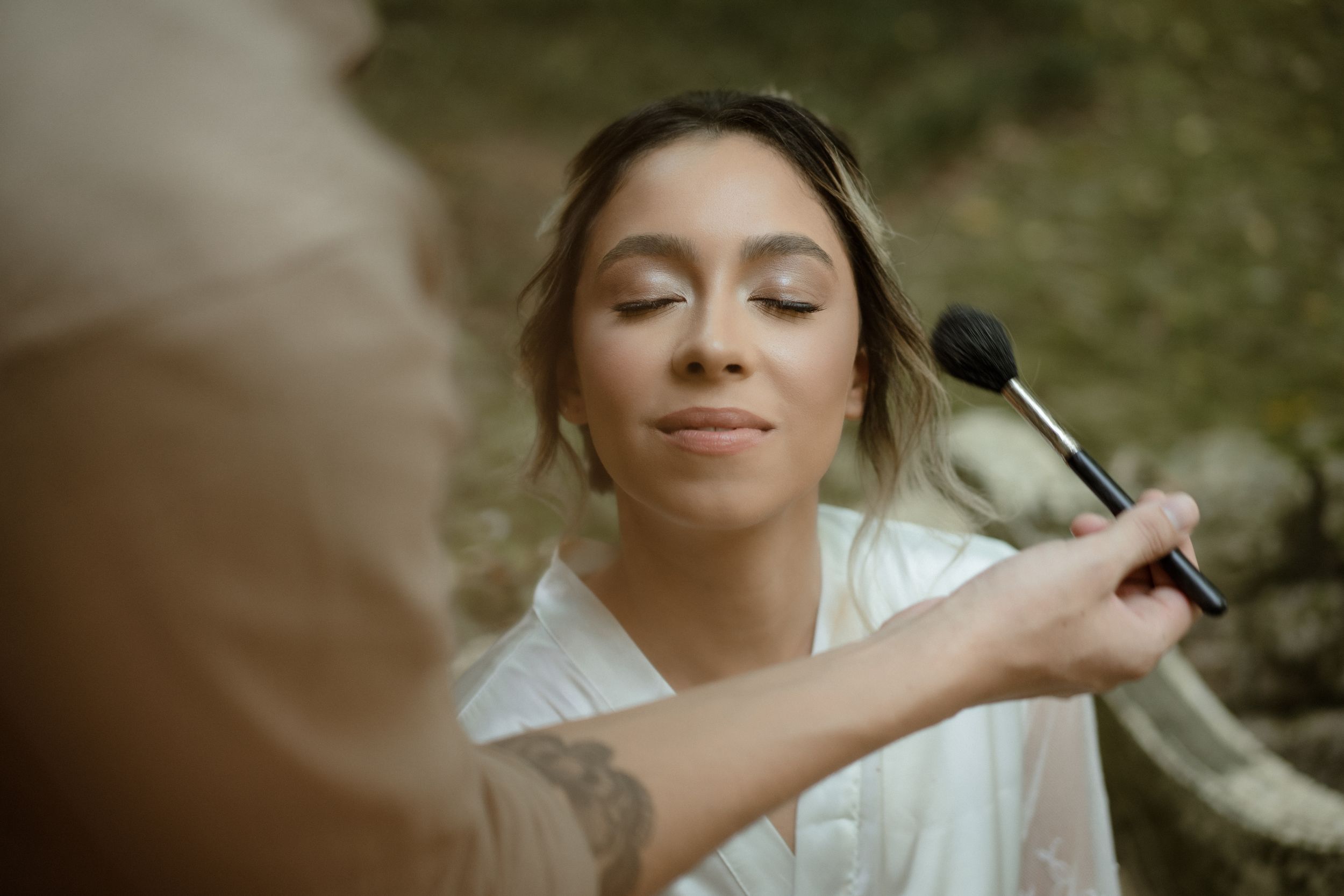 Intimate getting ready moments captured in warm natural lighting.