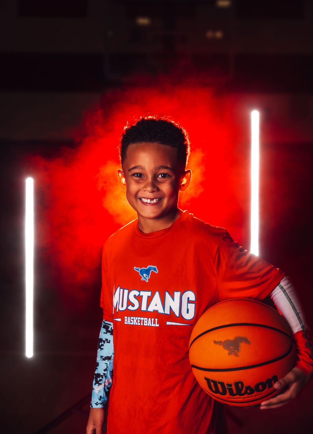 Sports portrait series with basketball player in red uniform against dramatic red smoke effects.