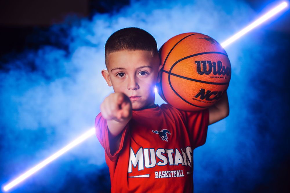 Basketball themed portrait series with glowing blue backlighting and dramatic smoke effects.