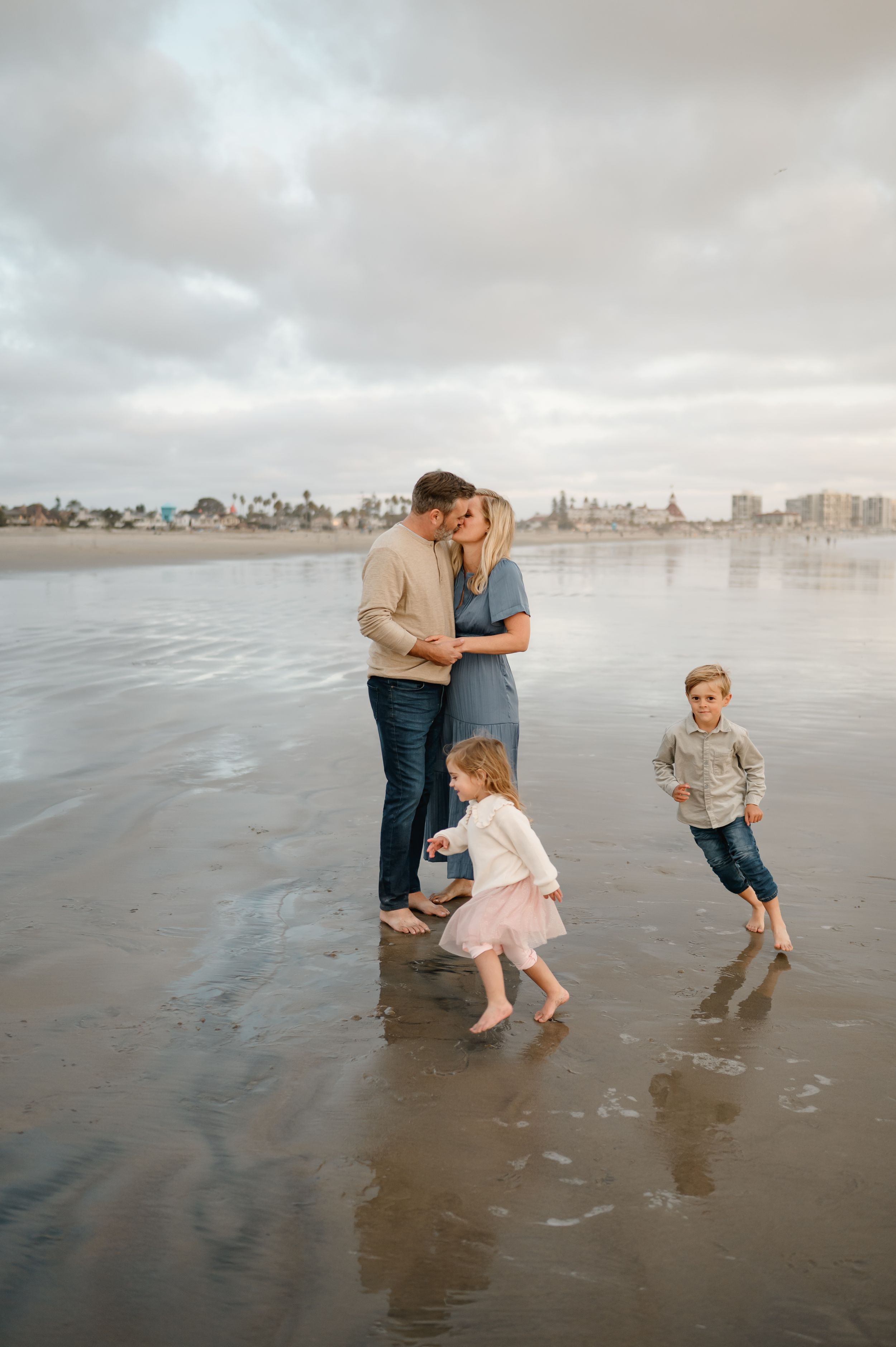 A family of four standing on a beach during Ventura beach family photoshoot by Camarillo family photographer
